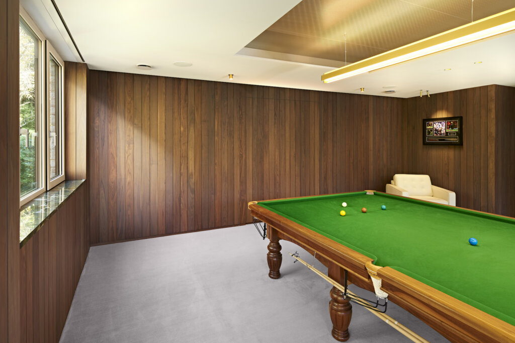 A view showing how the cue cupboard in the contemporary snooker room disappears into the panelling when the doors are shut