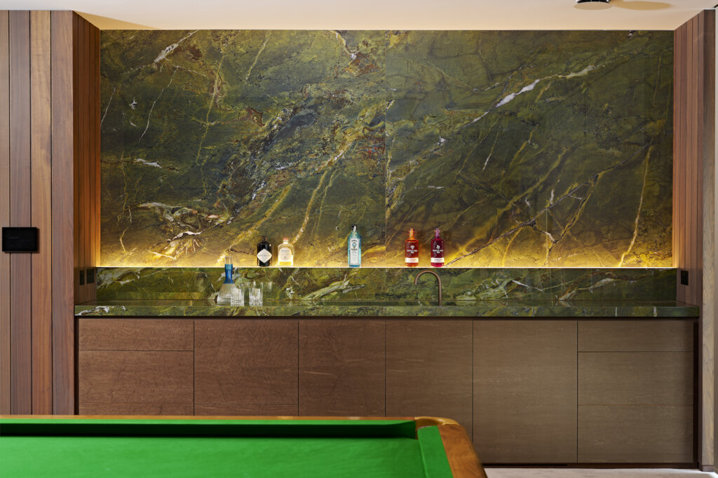 a face on view of the bar with its lit shelf and green marble