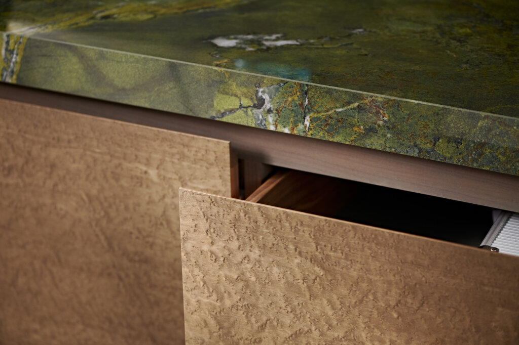 a detail shot of an open drawer in the bar showcasing the grain of the birds eye maple